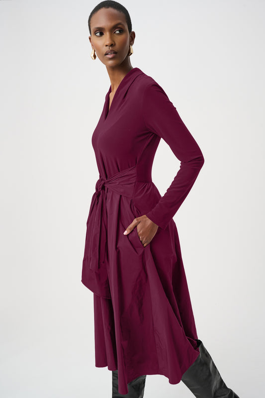 Long-sleeved fit-and-flare dress in black and elderberry with a front sash on the bodice and a gathered skirt