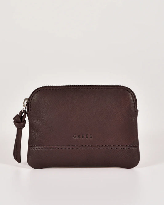 Small soft leather Gabee pouch with top zip, silver hardware and a keychain, shown in a rich colour.
