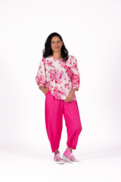 Floral top in Crush Pink with dramatic gathered sleeves, a clean rounded neckline and a relaxed, flowing shape
