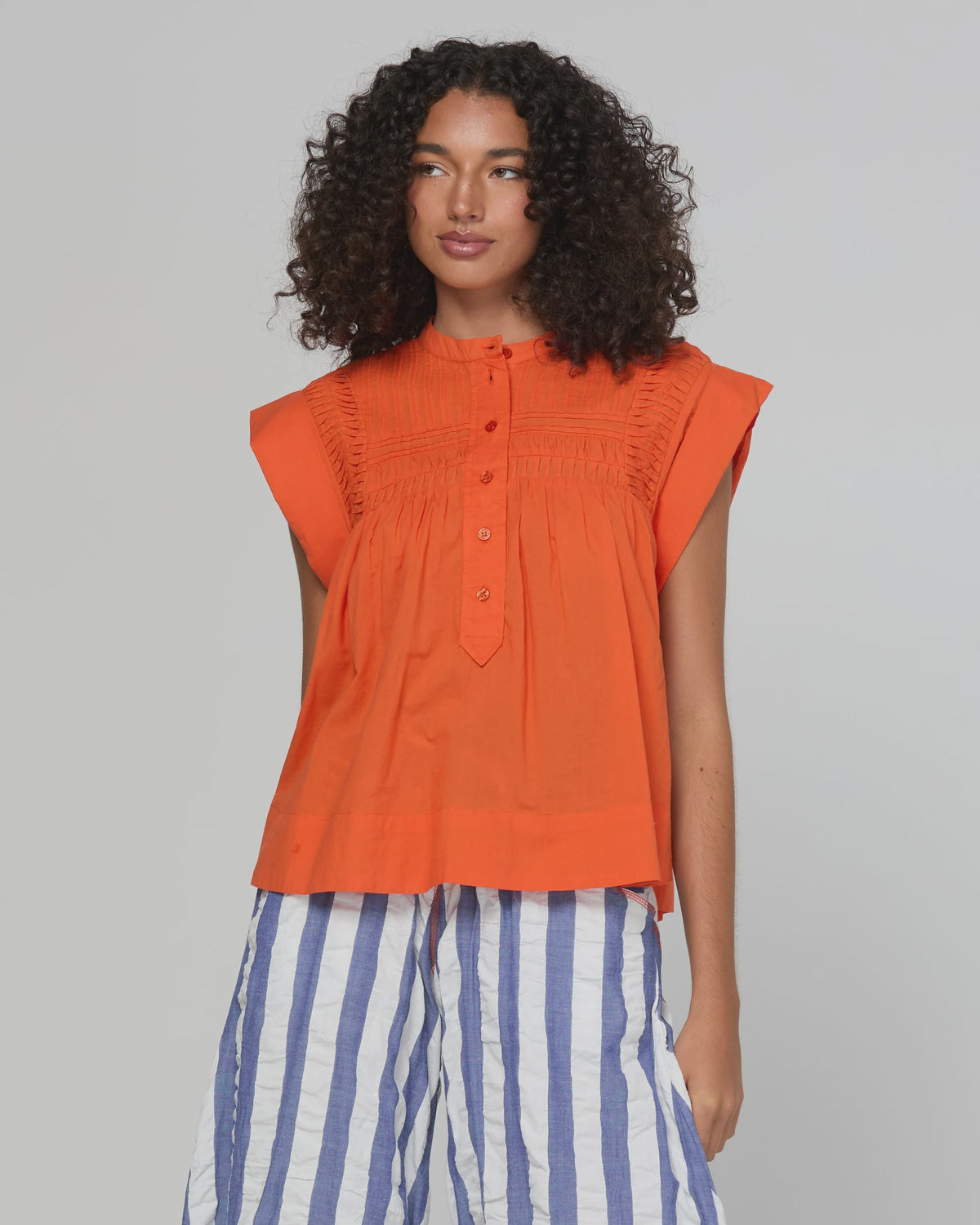 Chilli red cotton blouse with button front, shirred chest and rolled sleeves
