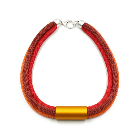 Necklace of three twisted cords in burgundy, red and orange joined by a gold-toned metal tube