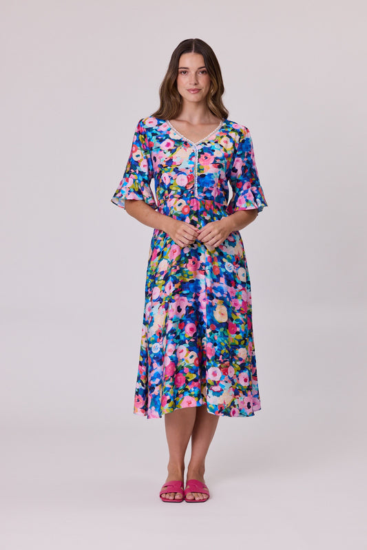 Black and blue floral dress with ruffle trim at the neckline, short flutter sleeves and a gathered back