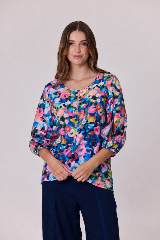Floral print top with three-quarter sleeves and a scoop neckline, worn as a relaxed, flattering fit