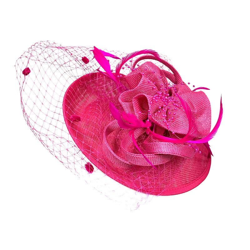 Pink fascinator with intricate detailing, shown with the headband and hair clip it comes with