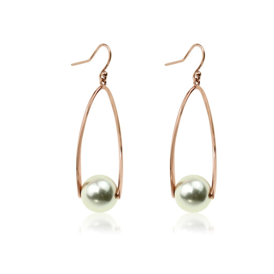 Rose gold open twist drop earrings with a creamy glass pearl hanging from each, on fishhook wires