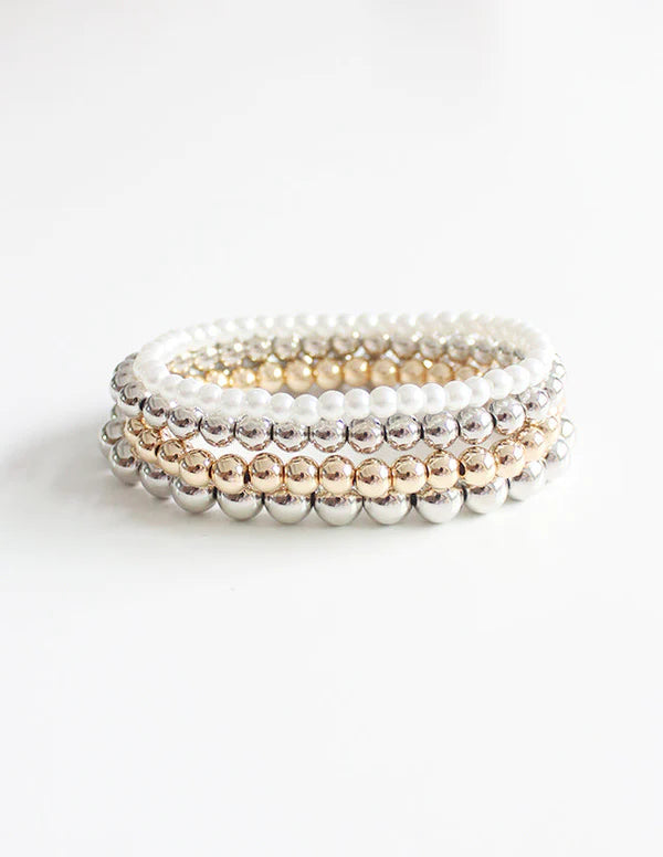Boho mixed strand bracelet in shiny gold and silver tones with multiple linked strands, shown as a single piece of jewellery