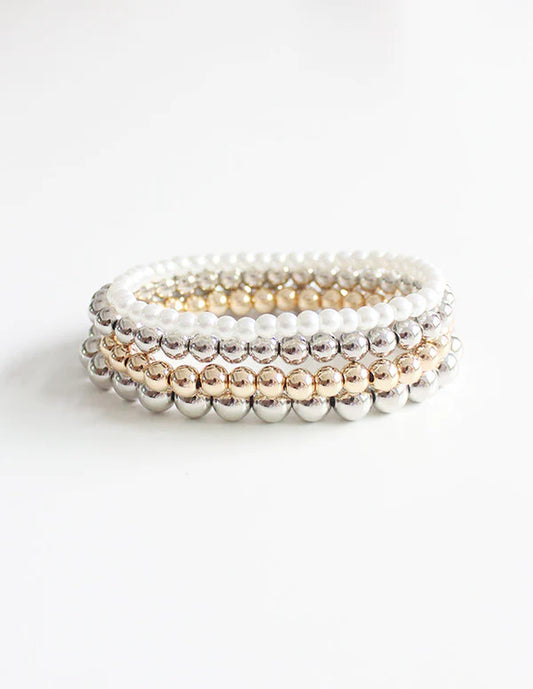 Boho mixed strand bracelet in shiny gold and silver tones with multiple linked strands, shown as a single piece of jewellery