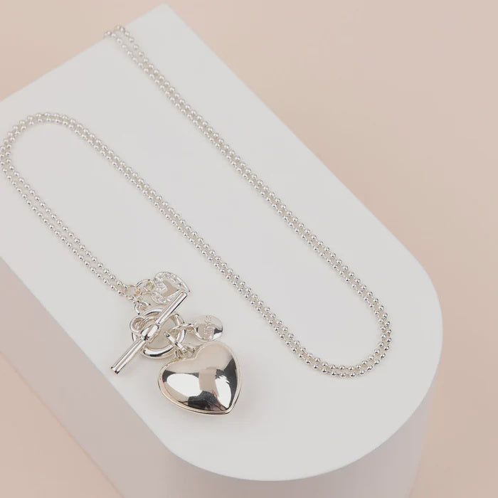 Long silver-plated ball chain necklace with a small heart pendant and matching bracelet, in a light gold heart design