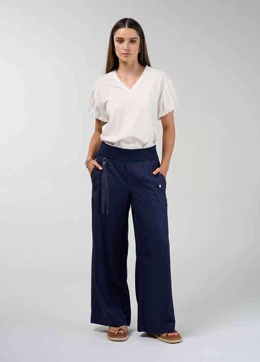 Navy and palm green wide-leg trousers with a ribbed waistband, flap pockets with dome accents and a metal ring tab