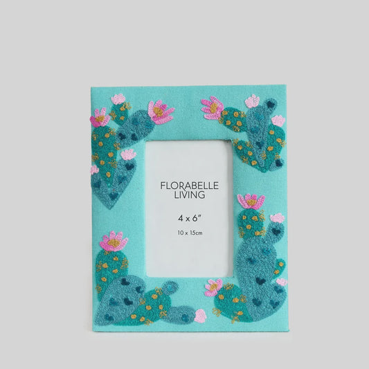 Decorative embroidered photo frame with a playful teal cactus motif