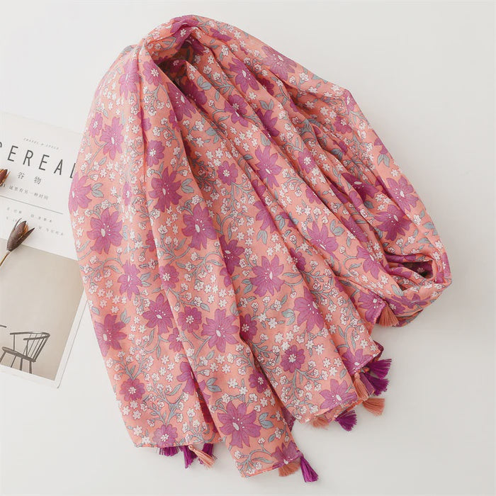 Purple floral scarf with tassels at each end, shown draped to display its soft, lightweight fabric and print