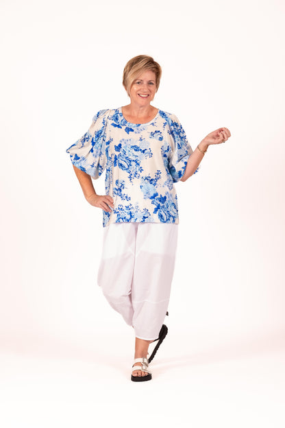 Blue and white floral top with gathered statement sleeves and a clean rounded neckline, shown in the Floral Blue Crush print