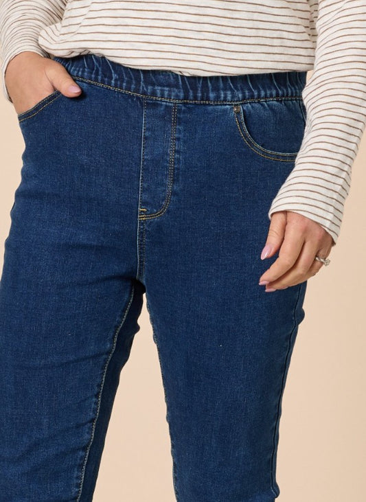 Dark denim high rise slim leg pull-on jeans with an ankle-grazer length, shown from the waist down