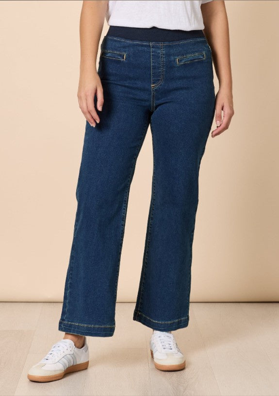 Dark denim wide-leg pull-on jeans with a high rise and full-length leg, worn standing, on a plain background