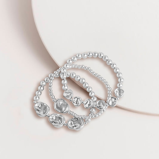 Set of three silver nugget bead stretch bracelets with a plated metal finish, shown together