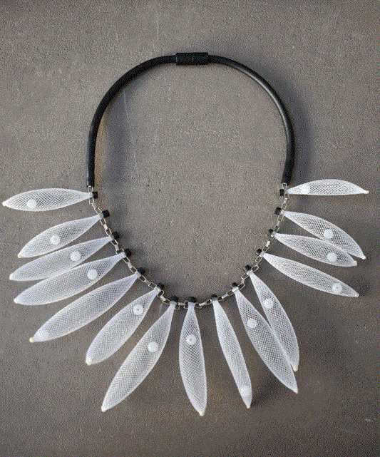 Black cord collar necklace with a short link section holding several small mesh pods, by Mingk