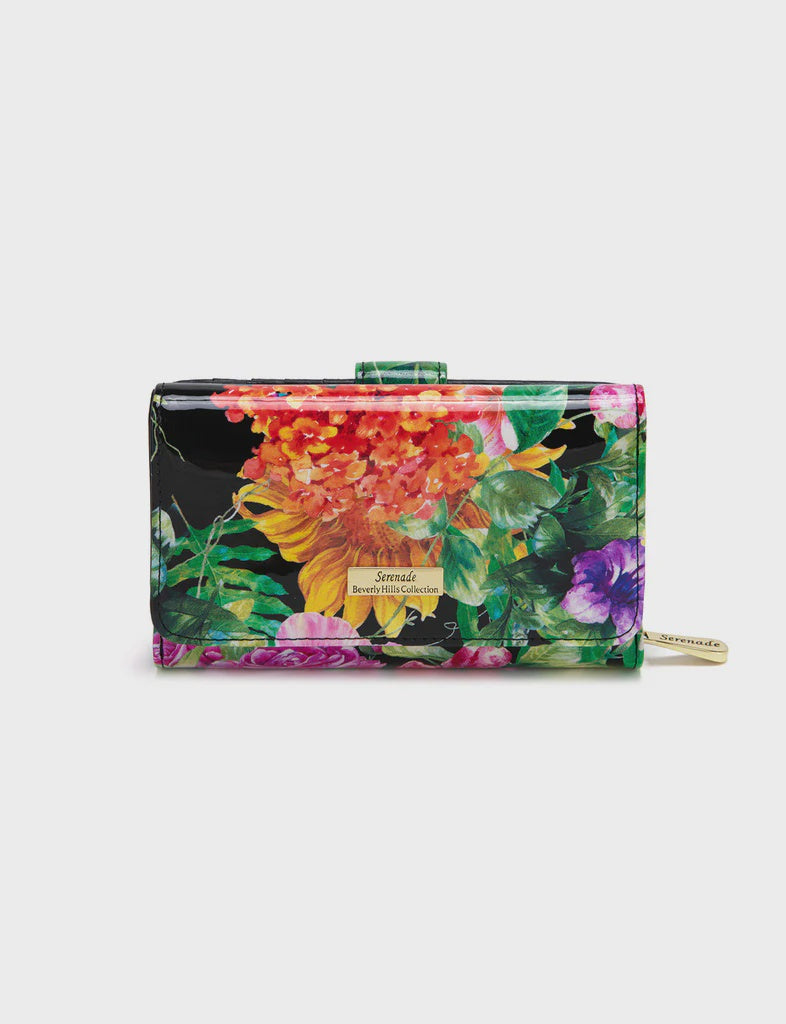 Serenade Lauren medium patent leather wallet with a gold fitting detail, shown closed