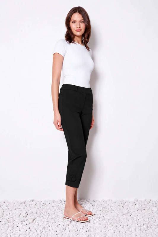 Woman wearing black cropped pull-on pants with a tab at each hem, a white tee and white sandals