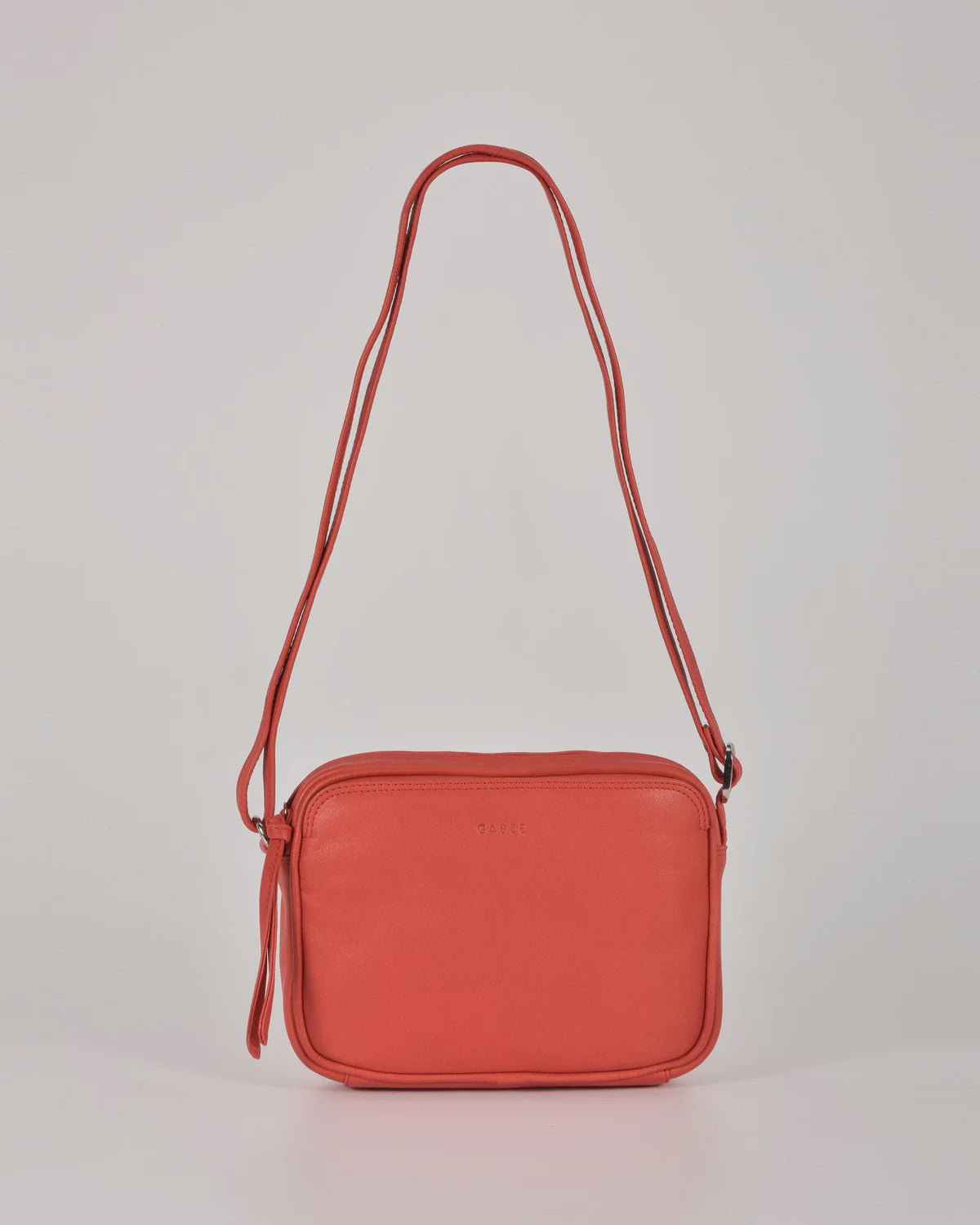 Darcy leather camera bag by Gabee with silver hardware, top zip, exterior slip pockets and an adjustable buckle strap