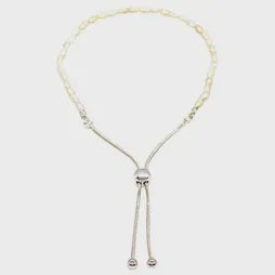 Bracelet of tiny cream freshwater pearls strung together with a silver slider clasp for adjustable sizing