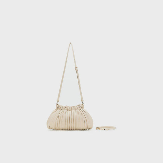 Black and ivory pleated dumpling-shaped bag with brushed gold hardware, zip top and a short top handle