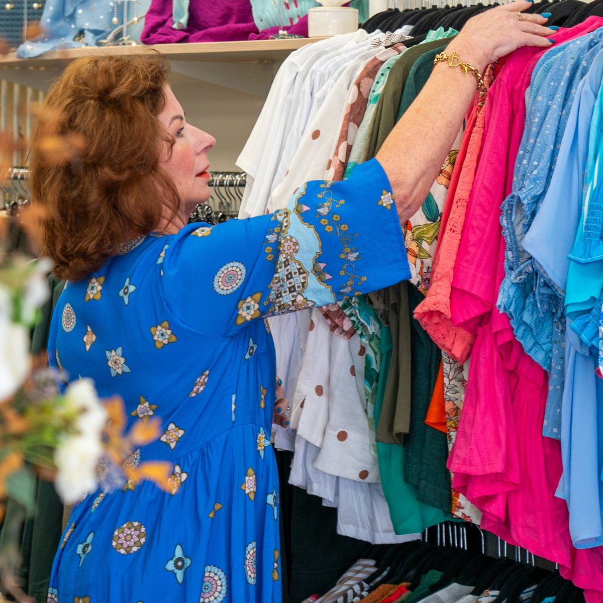 Debbie browsing the rails of colourful tops at So You! Boutique