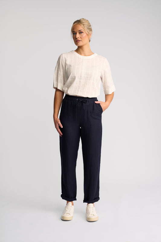 Slim-leg pull-on pants in a linen viscose blend with an elastic waistband, shown in ink, with a soft drape that grazes the ankle