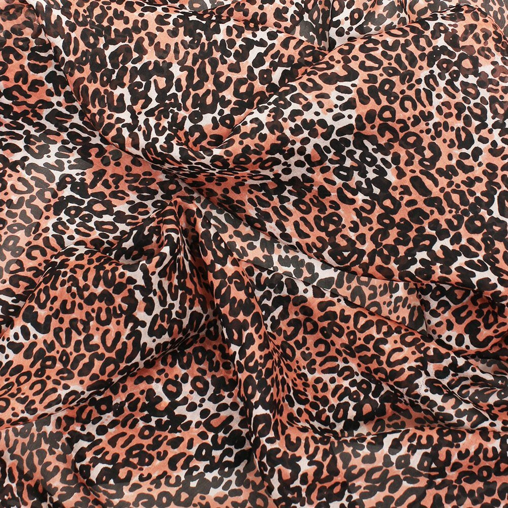 Oblong pure silk scarf with a leopard print in rust and black, shown beside a teal and black colourway, with stitched edges