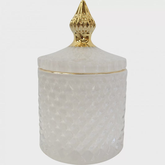 White glass cylindrical trinket jar with a thin gold band and a textured white lid topped with a gold spire finial