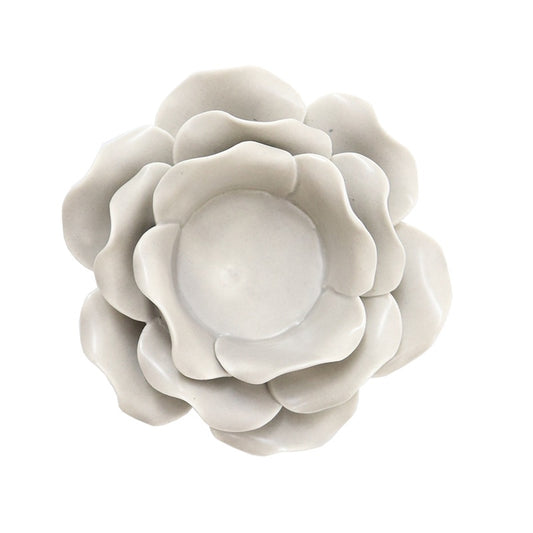 Off white porcelain flower tealight with black detail, shaped like an open bloom with a central cup for a candle