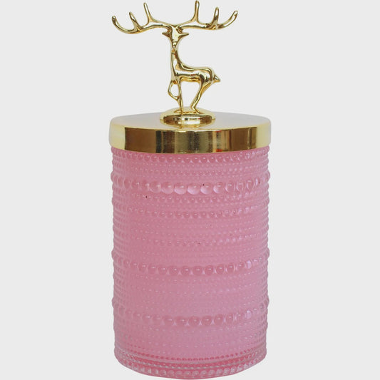 Ribbed glass trinket jar with a gold metal lid topped by a small gold reindeer handle, shown in Tango pink and white