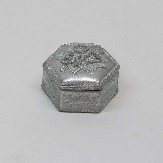 Small hexagon-shaped decorative box in matte antique pewter with a raised rose motif on the lid