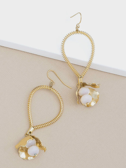 Pair of gold drop earrings with a small gold bell and white stones hanging from the ear wire