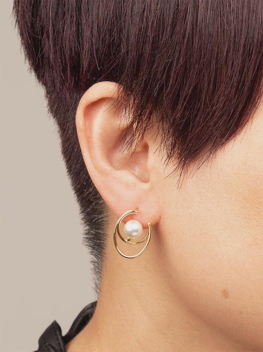 Small circular abstract metal stud earring with a single pearlescent bead and post back